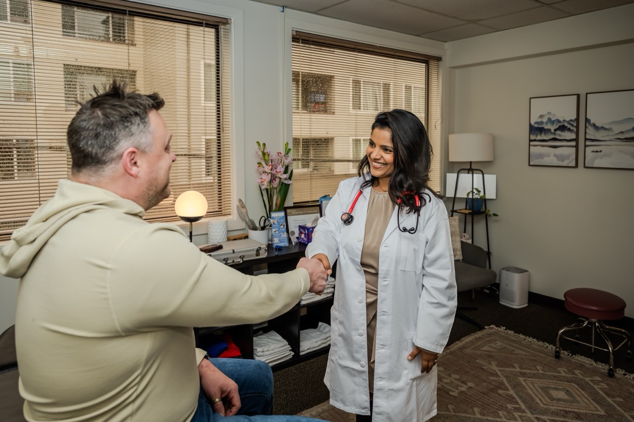 Dr. Neha shaking hands with a patient
